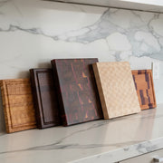 Collection of wooden cutting boards with various patterns on a white background