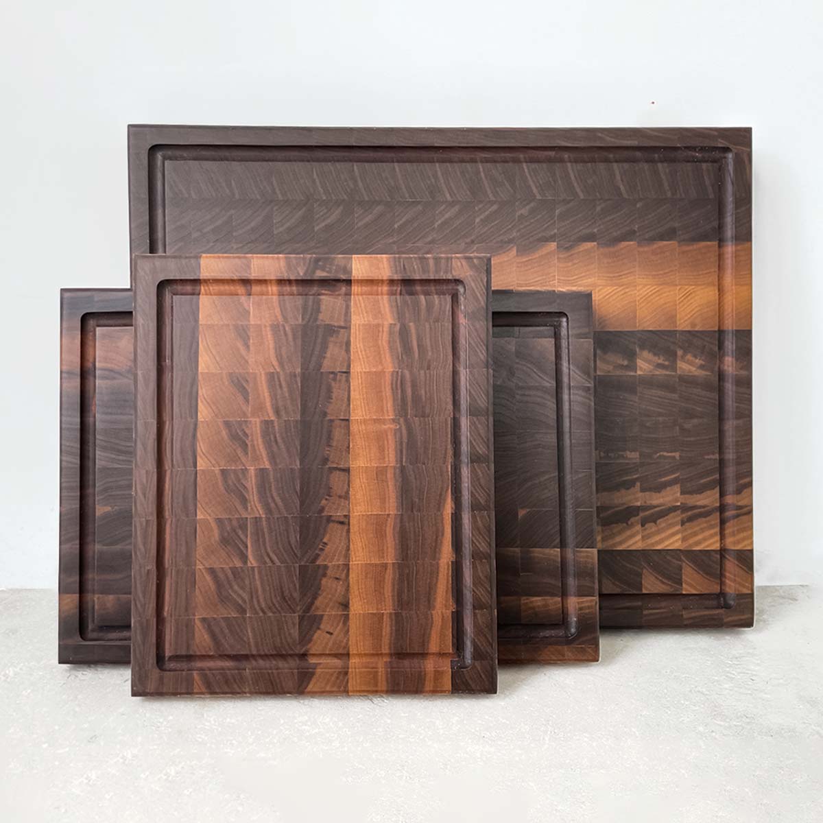 The Hawthorne set of 3 walnut end grain cutting boards is a best seller. The boards feature an arrowhead pattern providing an attractive and functional surface to cut and chop on. The end grain construction is gentle on knives and makes The Hawthorne a favourite among chefs. A staple kitchen accessory.