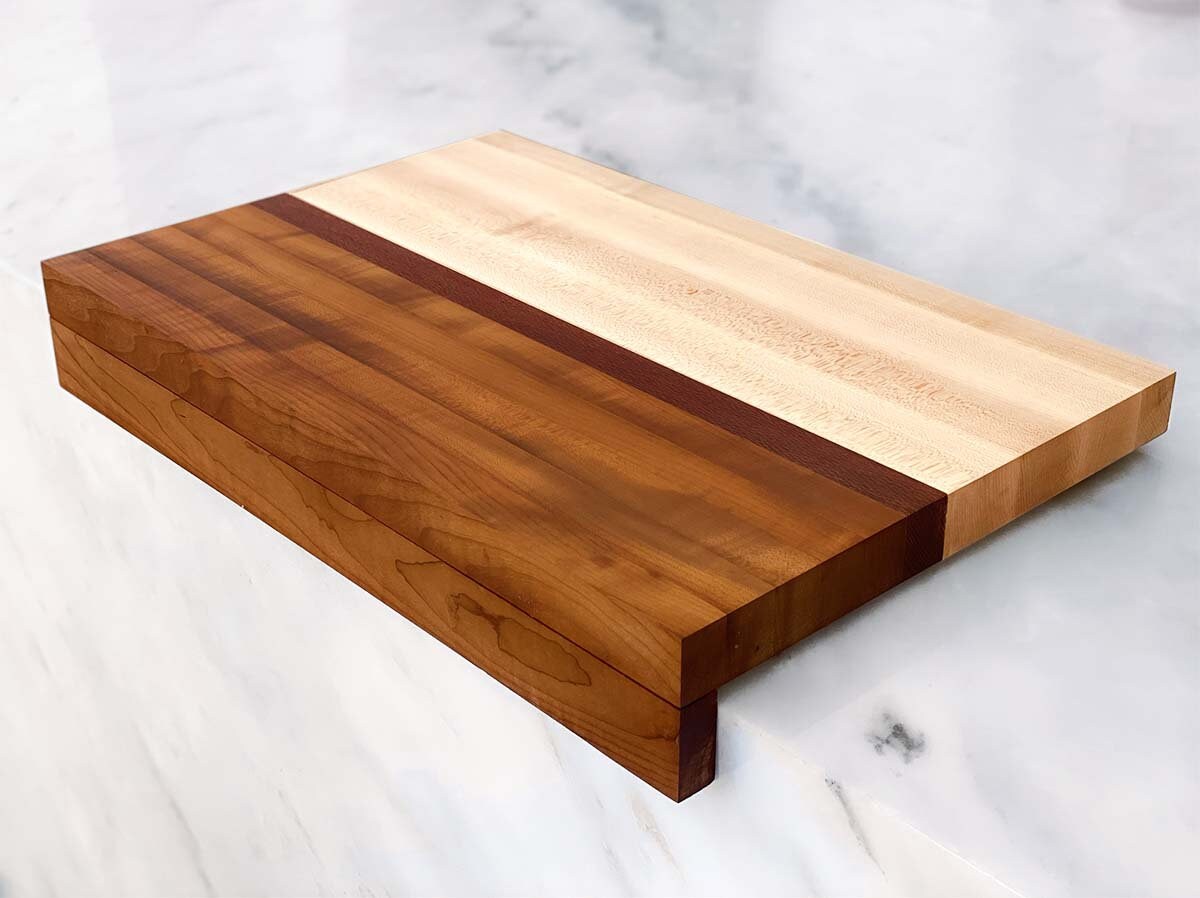Discover The Bay—the perfect cutting companion. Whether you’re an avid cook or a weekend warrior, this stylish, edge grain cutting board will become your go-to for meal prep. Crafted from sugar maple, leopardwood and lightly toasted maple, it&#39;s a unique cutting board that can be portable with its removable magnetic slider bar. Get the best of 